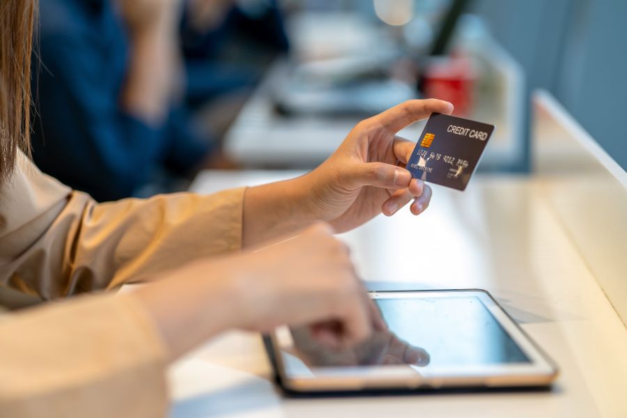 Woman using a credit card with tablet